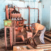 Coffee farmer working on a coffee pulping machine.
