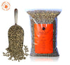green coffee scoop with clear bag of green coffee beans